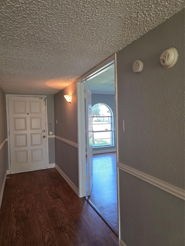 5501 Miami Dr, Rowlett, TX 75088 - corridor featuring wood finished floors, a textured ceiling, and baseboards