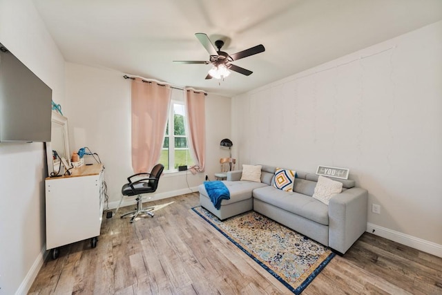 825 Holbrook Rd, Springtown, TX 76082 - living room featuring ceiling fan, wood finished floors, and baseboards