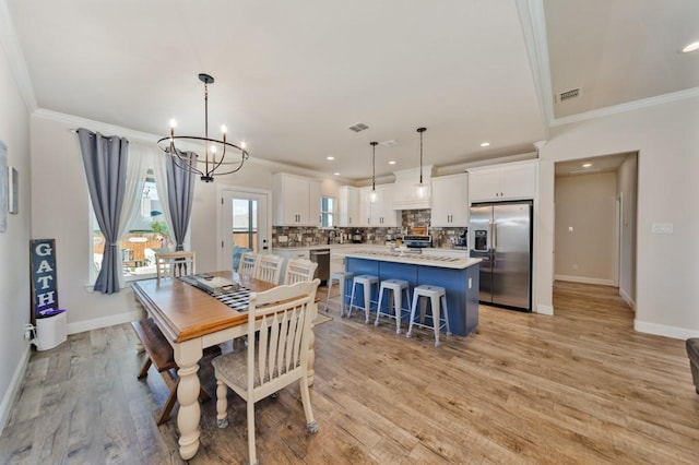 dining space with crown molding, a chandelier, baseboards, light wood-type flooring, and recessed lighting