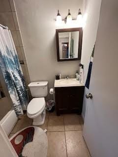 full bathroom featuring toilet, tile patterned flooring, vanity, and shower / tub combo with curtain