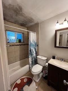 214 Pecos St, Garland, TX 75041 - full bathroom with vanity, shower / bath combination with curtain, toilet, and tile patterned floors