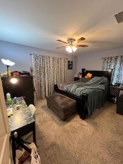 carpeted bedroom with a ceiling fan