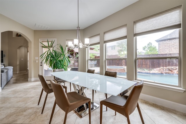 10900 Old Saybrook Ln, Frisco, TX 75033 - dining area with arched walkways, healthy amount of natural light, and a chandelier