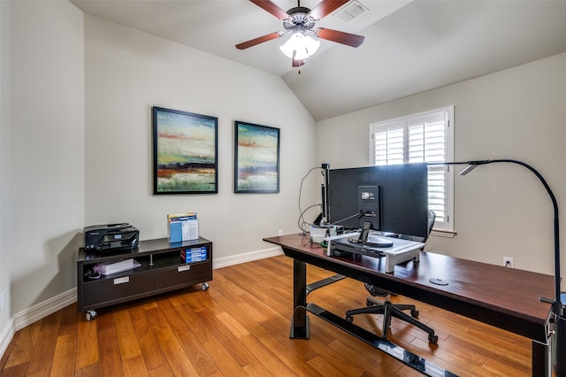 office space with baseboards, vaulted ceiling, light wood-style flooring, and a ceiling fan