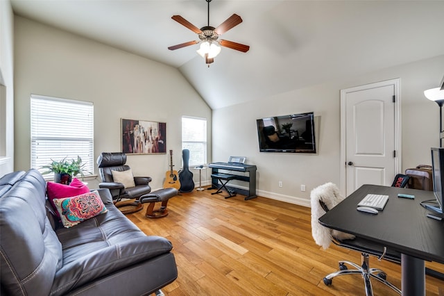 office with ceiling fan, vaulted ceiling, light wood-style floors, and baseboards