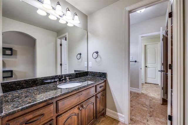 bathroom with baseboards and vanity