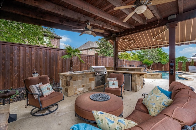 view of patio with exterior kitchen, a fenced backyard, ceiling fan, a grill, and outdoor lounge area
