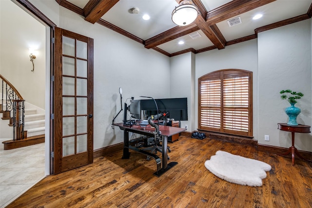 office space featuring wood finished floors, beamed ceiling, coffered ceiling, ornamental molding, and baseboards