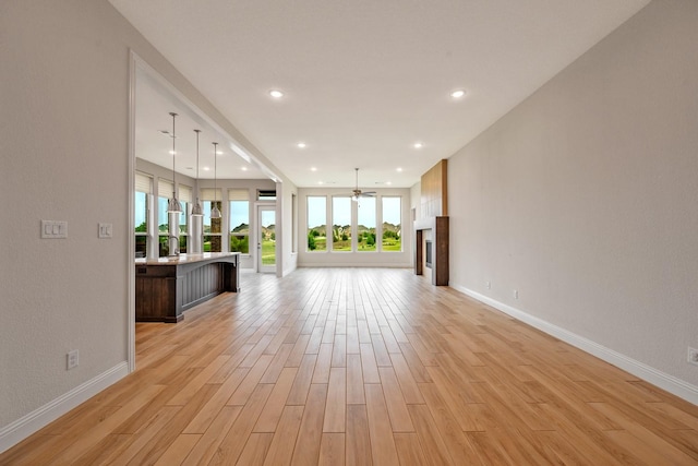 1116 Lake Hills Trl, Roanoke, TX 76262 - unfurnished living room with light wood-style floors, baseboards, recessed lighting, and a ceiling fan
