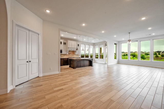 1116 Lake Hills Trl, Roanoke, TX 76262 - unfurnished living room with baseboards, a ceiling fan, recessed lighting, and light wood finished floors