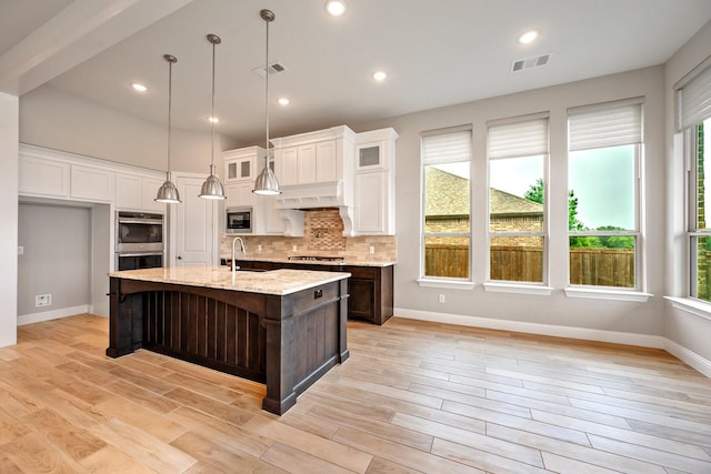 1116 Lake Hills Trl, Roanoke, TX 76262 - kitchen with stainless steel appliances, premium range hood, decorative backsplash, white cabinets, and a sink