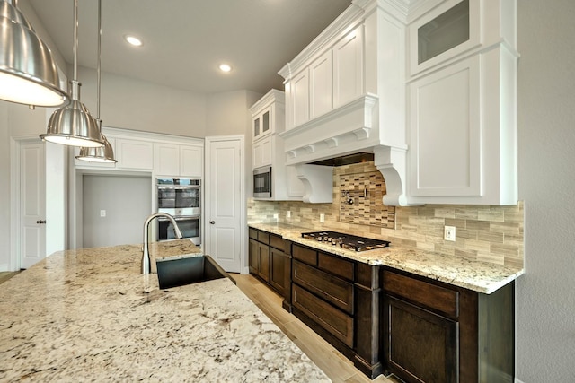 1116 Lake Hills Trl, Roanoke, TX 76262 - kitchen featuring stainless steel appliances, a sink, backsplash, white cabinets, and light stone counters
