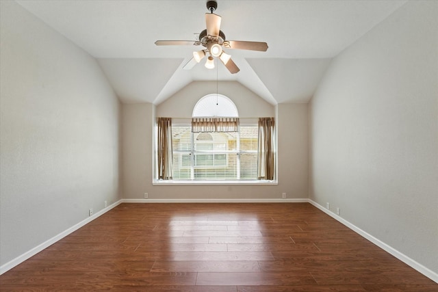unfurnished room with ceiling fan, wood finished floors, lofted ceiling, and baseboards