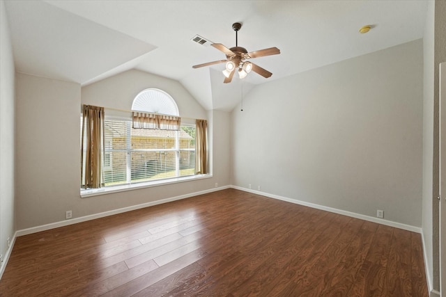 spare room featuring a ceiling fan, dark wood-style flooring, lofted ceiling, and baseboards