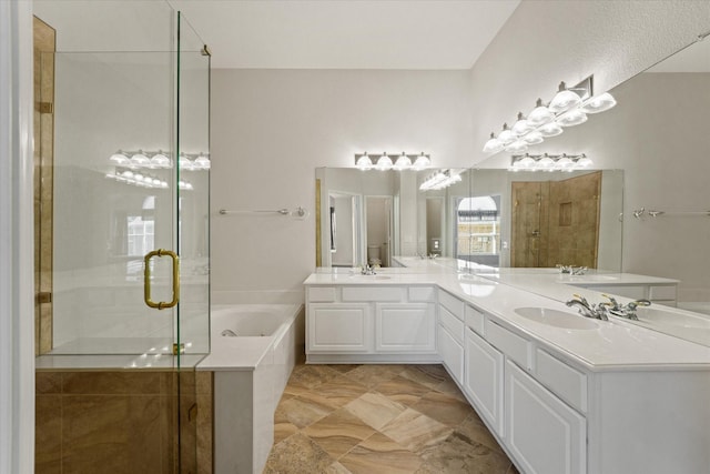 bathroom with a bath, a stall shower, and double vanity