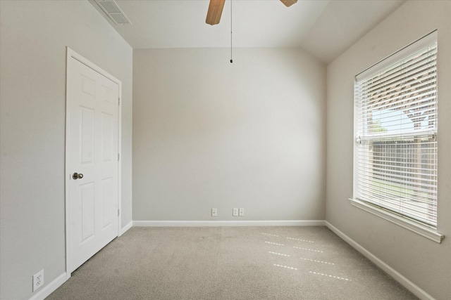 carpeted spare room featuring ceiling fan, baseboards, and lofted ceiling