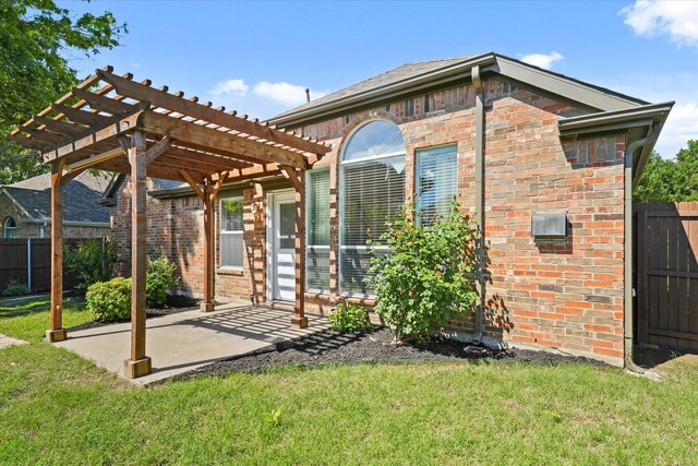 back of house with brick siding, a pergola, and a patio area
