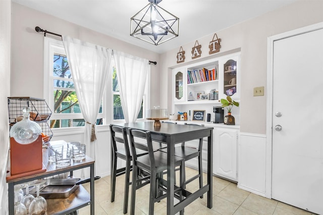 1032 Peach Ln, Desoto, TX 75115 - dining room featuring a chandelier, light tile patterned floors, and wainscoting