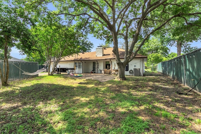 1032 Peach Ln, Desoto, TX 75115 - back of house with a chimney, a fenced backyard, and a patio area