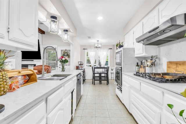 1032 Peach Ln, Desoto, TX 75115 - kitchen with ventilation hood, appliances with stainless steel finishes, light tile patterned floors, a sink, and white cabinetry