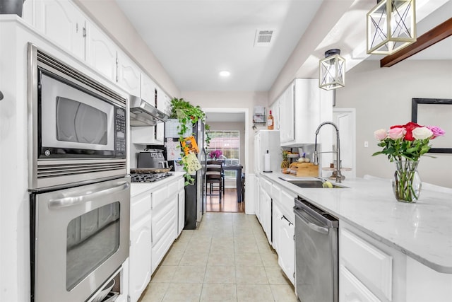 1032 Peach Ln, Desoto, TX 75115 - kitchen with appliances with stainless steel finishes, a sink, light tile patterned flooring, white cabinets, and recessed lighting