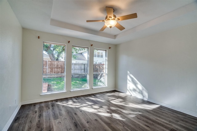 4804 Nocona Dr, Plano, TX 75024 - spare room with wood finished floors, baseboards, a tray ceiling, and a ceiling fan
