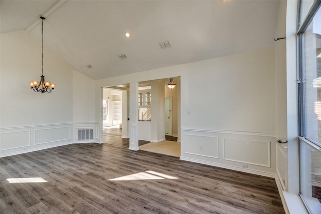 4804 Nocona Dr, Plano, TX 75024 - unfurnished room with a decorative wall, a chandelier, beam ceiling, healthy amount of natural light, and wood finished floors