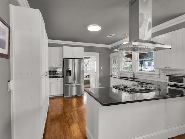 1942 Fairmount Ave, Fort Worth, TX 76110 - kitchen with stainless steel appliances, island range hood, a sink, ornamental molding, and tasteful backsplash