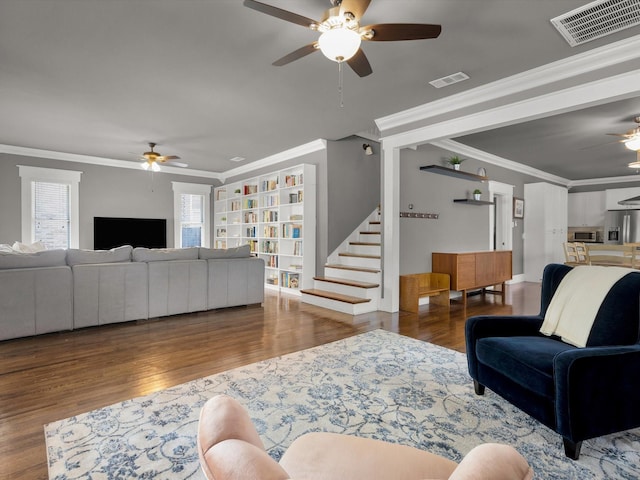 1942 Fairmount Ave, Fort Worth, TX 76110 - living room with ceiling fan, wood finished floors, ornamental molding, stairs, and built in features