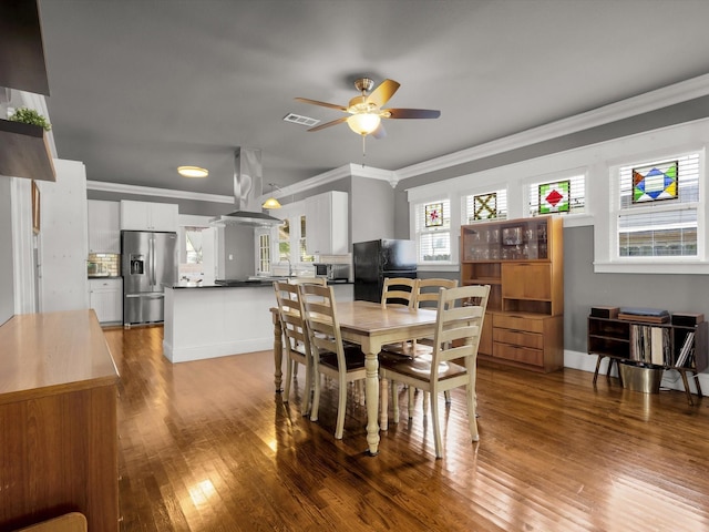 1942 Fairmount Ave, Fort Worth, TX 76110 - dining space featuring crown molding, ceiling fan, and wood-type flooring