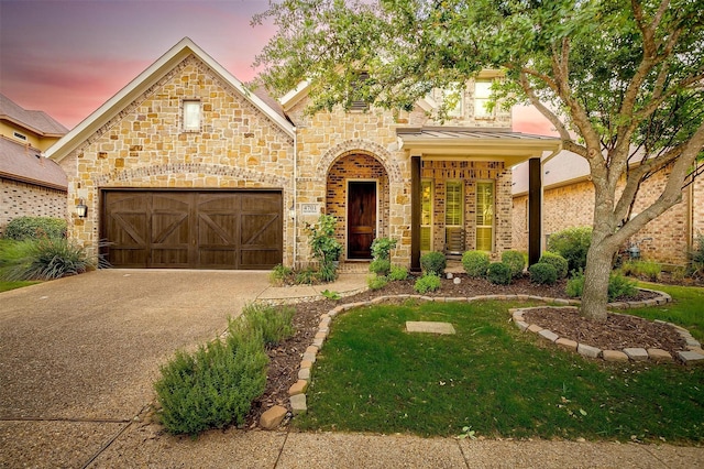 4701 Trevor Trl, Grapevine, TX 76051 - view of front facade with driveway, stone siding, a garage, a standing seam roof, and a front lawn