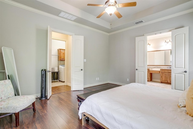 4701 Trevor Trl, Grapevine, TX 76051 - bedroom with washer / clothes dryer, a tray ceiling, ensuite bathroom, wood finished floors, and ornamental molding
