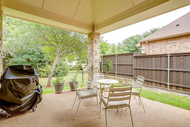 4701 Trevor Trl, Grapevine, TX 76051 - view of patio with outdoor dining space, a fenced backyard, and a grill