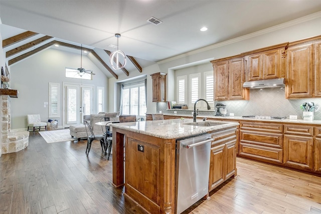4701 Trevor Trl, Grapevine, TX 76051 - kitchen with appliances with stainless steel finishes, a sink, under cabinet range hood, light stone countertops, and light wood-type flooring
