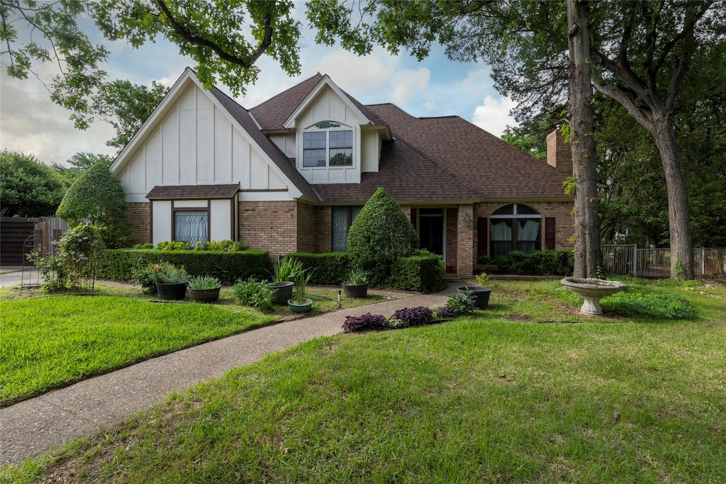 4706 El Brevo Ct, Arlington, TX 76017 - tudor home featuring brick siding, board and batten siding, a chimney, and a shingled roof