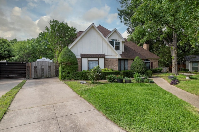4706 El Brevo Ct, Arlington, TX 76017 - tudor-style house with brick siding, board and batten siding, a shingled roof, a chimney, and a gate