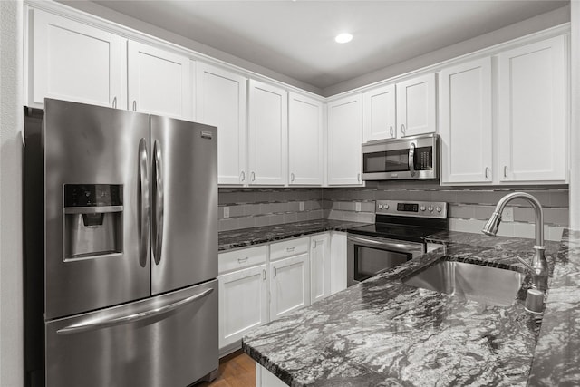 1317 Palm Canyon Dr, Dallas, TX 75204 - kitchen with appliances with stainless steel finishes, a sink, white cabinetry, and recessed lighting