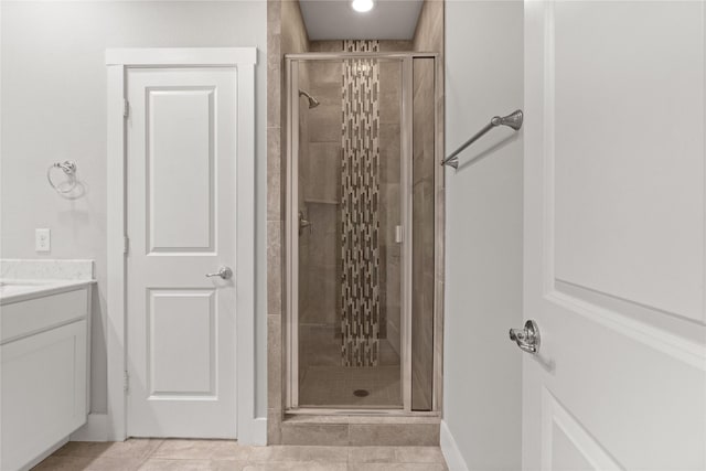 1317 Palm Canyon Dr, Dallas, TX 75204 - bathroom featuring a stall shower, tile patterned flooring, vanity, and baseboards