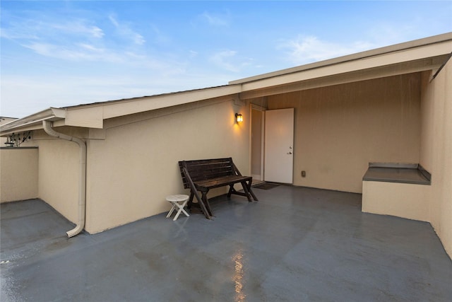 1317 Palm Canyon Dr, Dallas, TX 75204 - doorway to property with a patio area and stucco siding
