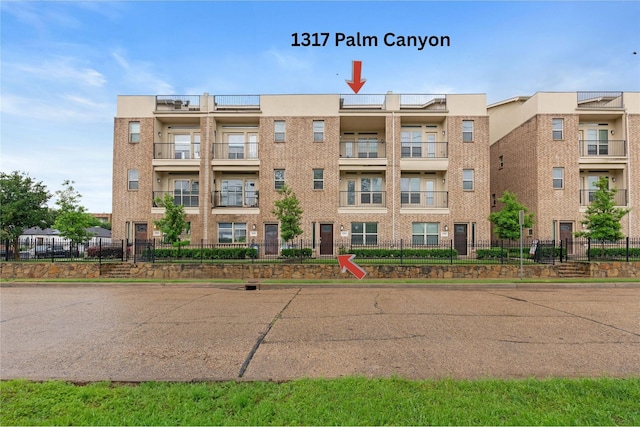 1317 Palm Canyon Dr, Dallas, TX 75204 - view of apartment building / complex with fence and uncovered parking