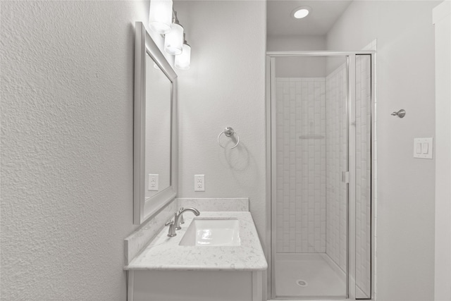 1317 Palm Canyon Dr, Dallas, TX 75204 - bathroom with a stall shower, a textured wall, and vanity