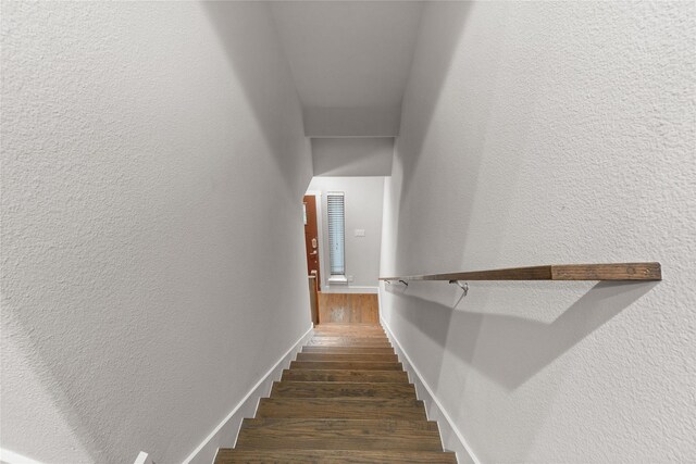 1317 Palm Canyon Dr, Dallas, TX 75204 - staircase with wood finished floors, a textured wall, and baseboards