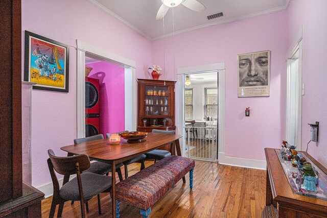 dining room with ceiling fan, light wood-style floors, crown molding, and baseboards