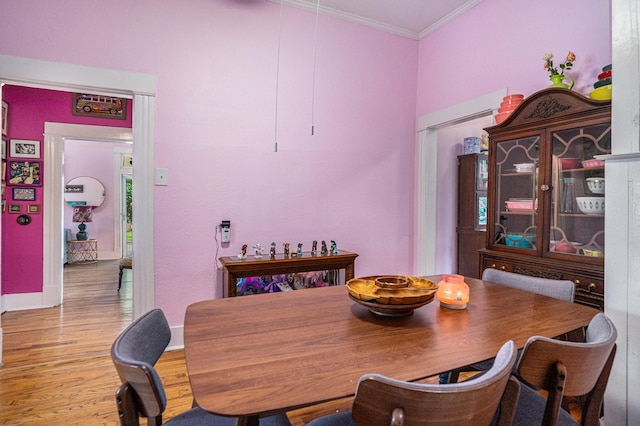 dining area featuring ornamental molding, wood finished floors, and baseboards