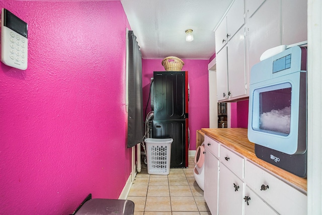 clothes washing area featuring light tile patterned floors