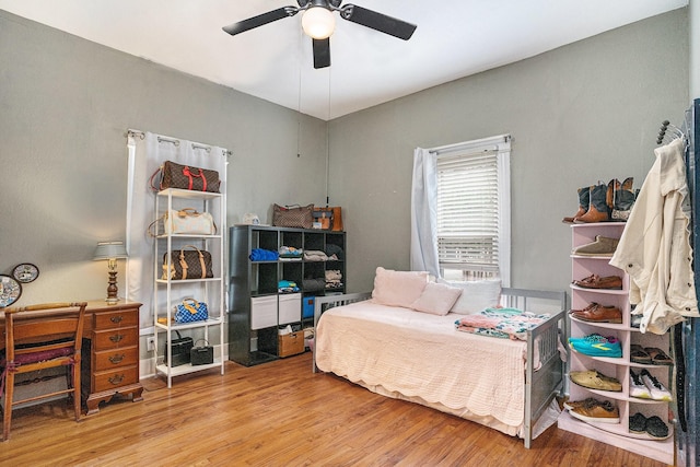 bedroom featuring wood finished floors and a ceiling fan