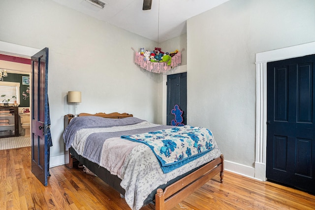 bedroom with wood finished floors and baseboards