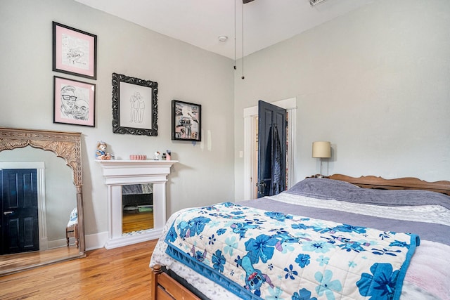 bedroom with wood finished floors and baseboards