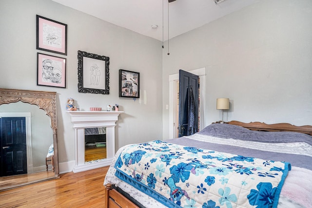 bedroom featuring wood finished floors and baseboards