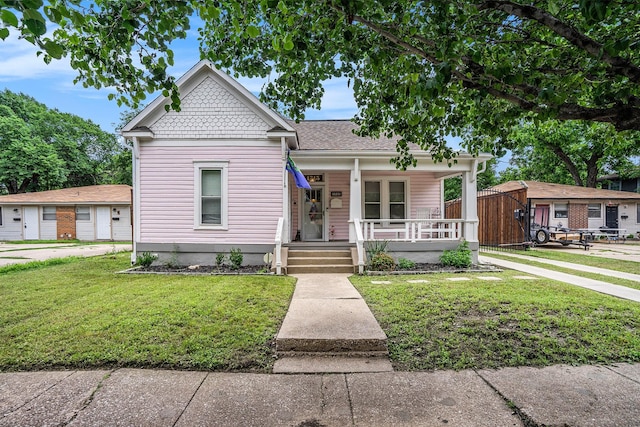 victorian home with covered porch and a front lawn